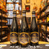 Botella de Gouden Carolus Christmas, una Belgian Strong Ale de Brouwerij Het Anker. La etiqueta tiene un diseño festivo en tonos oscuros y dorados. Con un ABV de 10.5%, ofrece aromas de frutas oscuras, caramelo y especias. Su sabor es equilibrado, con una base dulce de malta, amargor sutil y un final especiado. Ideal para acompañar estofados de carne, quesos fuertes y postres de chocolate. Su diseño refleja su carácter navideño.