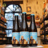 Botella de St. Bernardus Wit, una Witbier belga de la cervecería St. Bernardus, con un ABV de 5.5%. Ofrece aromas refrescantes de cáscara de naranja, cilantro y especias como el clavo. En boca, presenta sabores cítricos y especiados, con un final seco y un sutil dulzor maltoso. Ideal para maridar con mariscos, ensaladas frescas, pollo a la parrilla y quesos suaves.