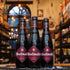 Botella de Westmalle Dubbel, una cerveza trapense belga de estilo Belgian Dubbel. La etiqueta es burdeos con el logo trapense. ABV de 7%. Sabor rico y complejo con notas de caramelo, maltas tostadas, frutas maduras y un toque de chocolate. Ideal para acompañar guisos de carne, estofados y quesos fuertes. El diseño refleja la tradición cervecera de los monjes de la Abadía de Westmalle.